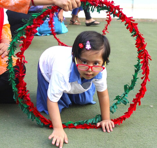 Children practicing balance in a Young Athletes session